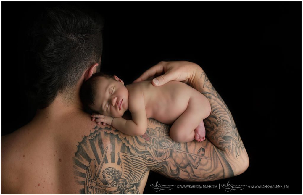 photograph of newborn baby on tattooed dads arm in Mechanicsburg PA with Karissa Zimmer Photography