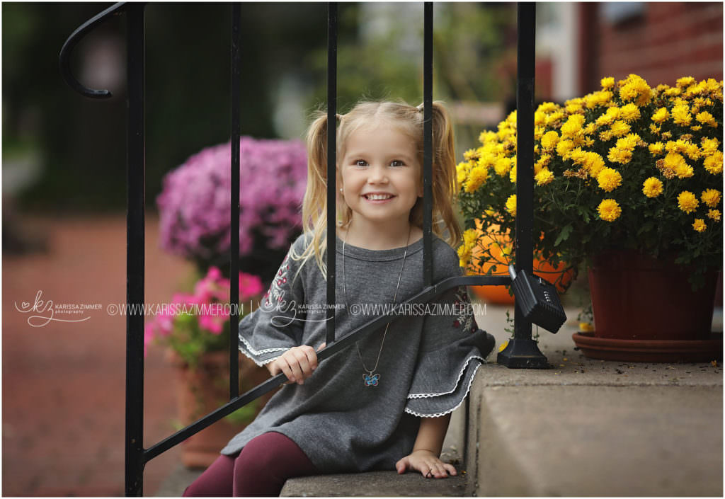 picture of little girl with fall flowers by karissa zimmer photography