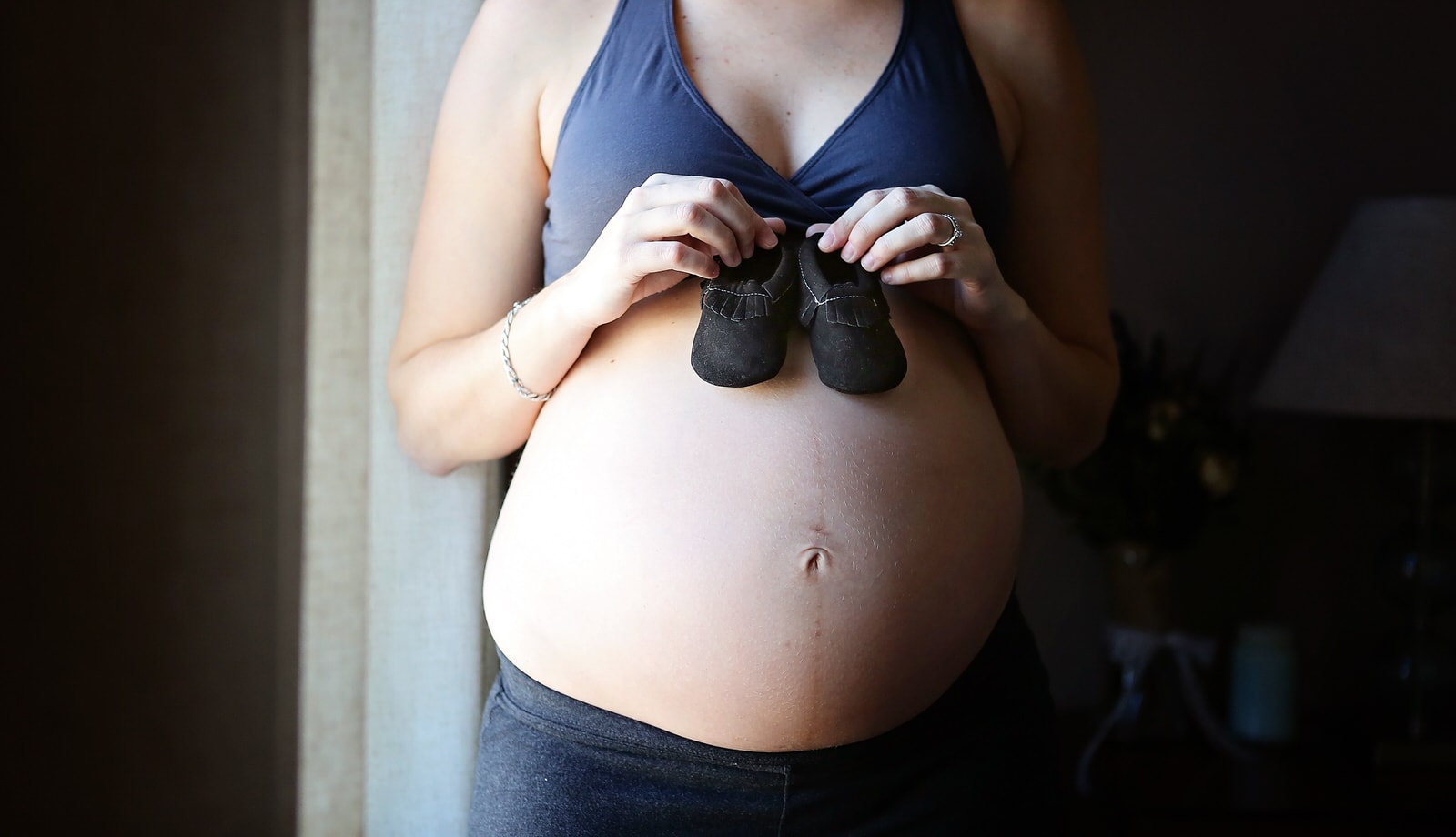 maternity photoshoot with baby shoes