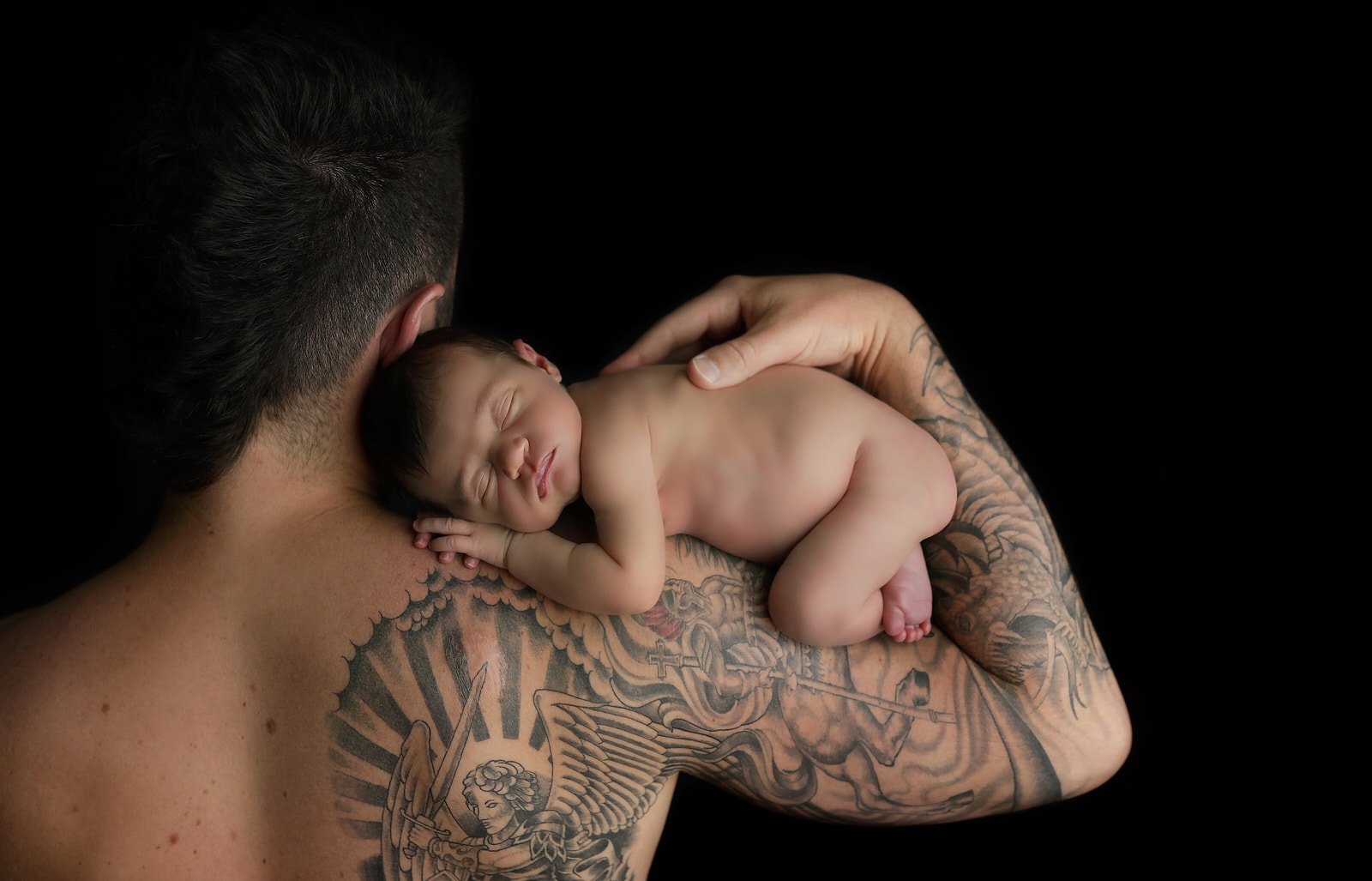 harrisburg pa newborn photographer caputres newborn baby girl on dads tattooed arm