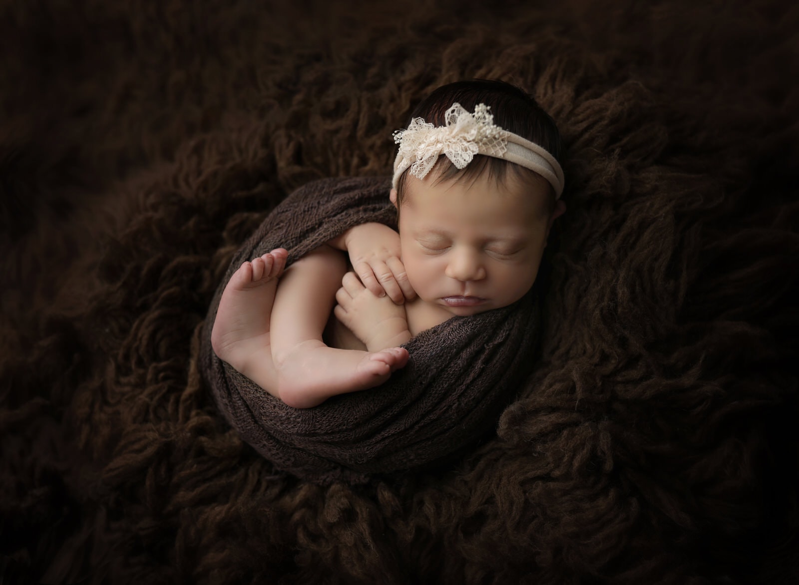 Karissa zimmer photography captures newborn girl on brown background near harrisburg pa