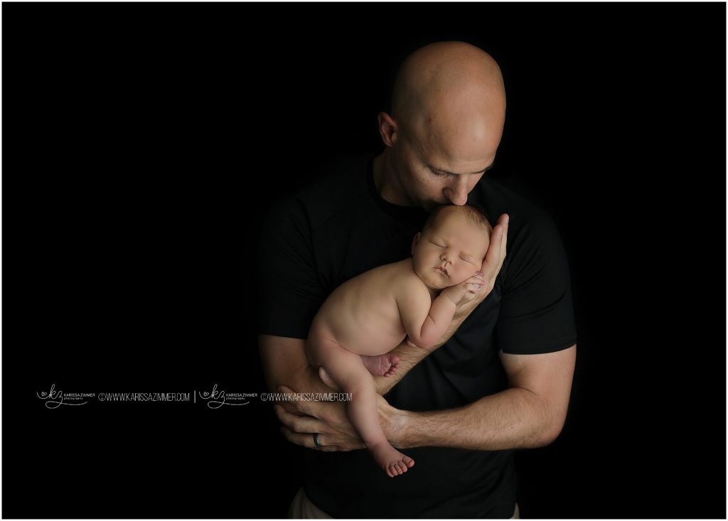newborn and father pose by karissa zimmer
