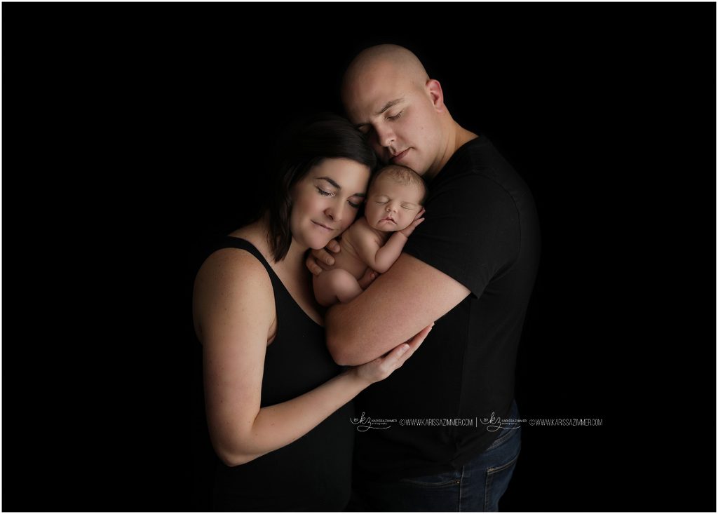 new parents are photographed with their baby boy by karissa zimmer photography