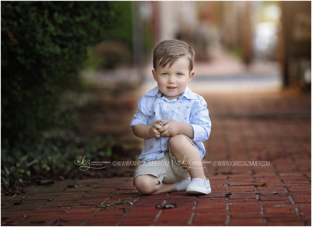 little boy poses during his family maternity photo session
