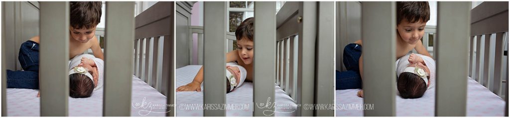 little boy checks out his new baby sister