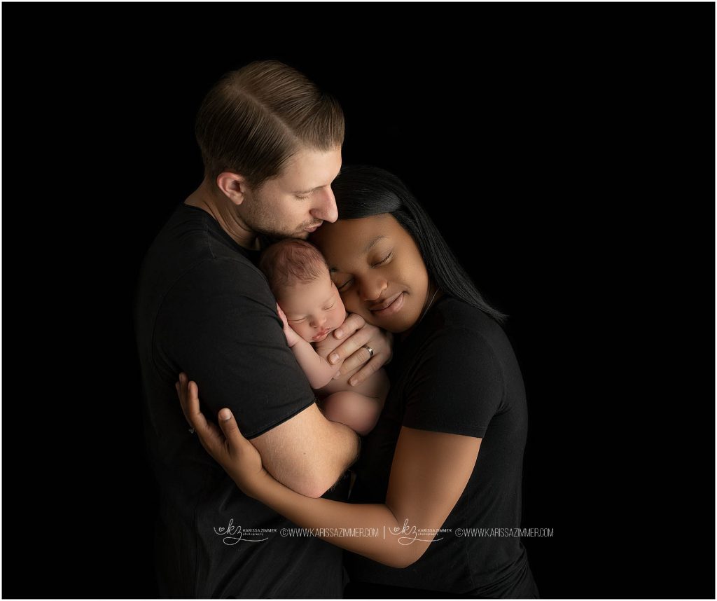 new parents snuggle their newborn boy at photo session in camp hill pa
