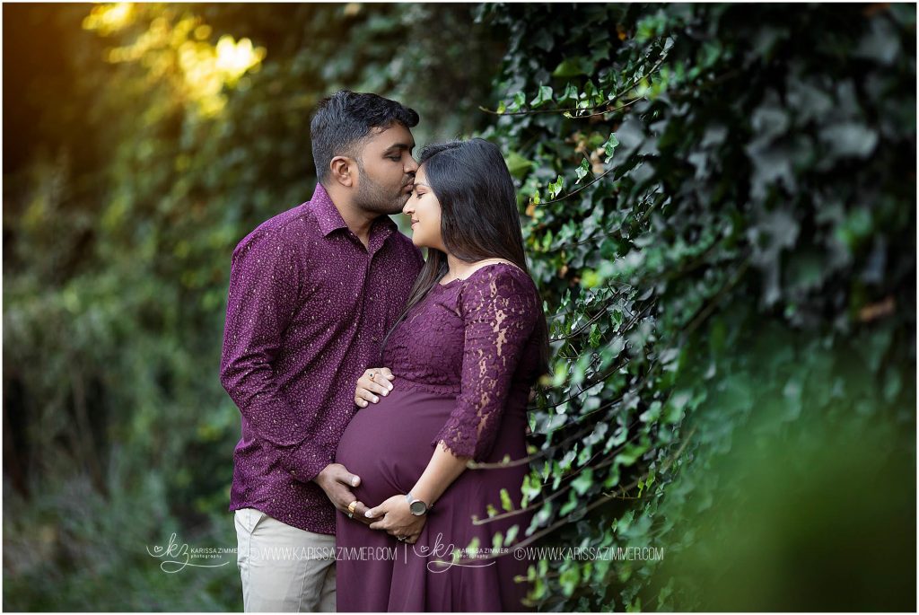 husband kisses wife on the forehead at their camp hill maternity session