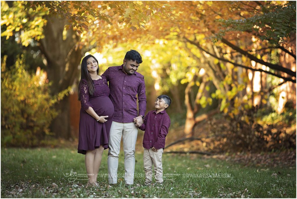 parents pose with their little boy during maternity session with karissa zimmer photography