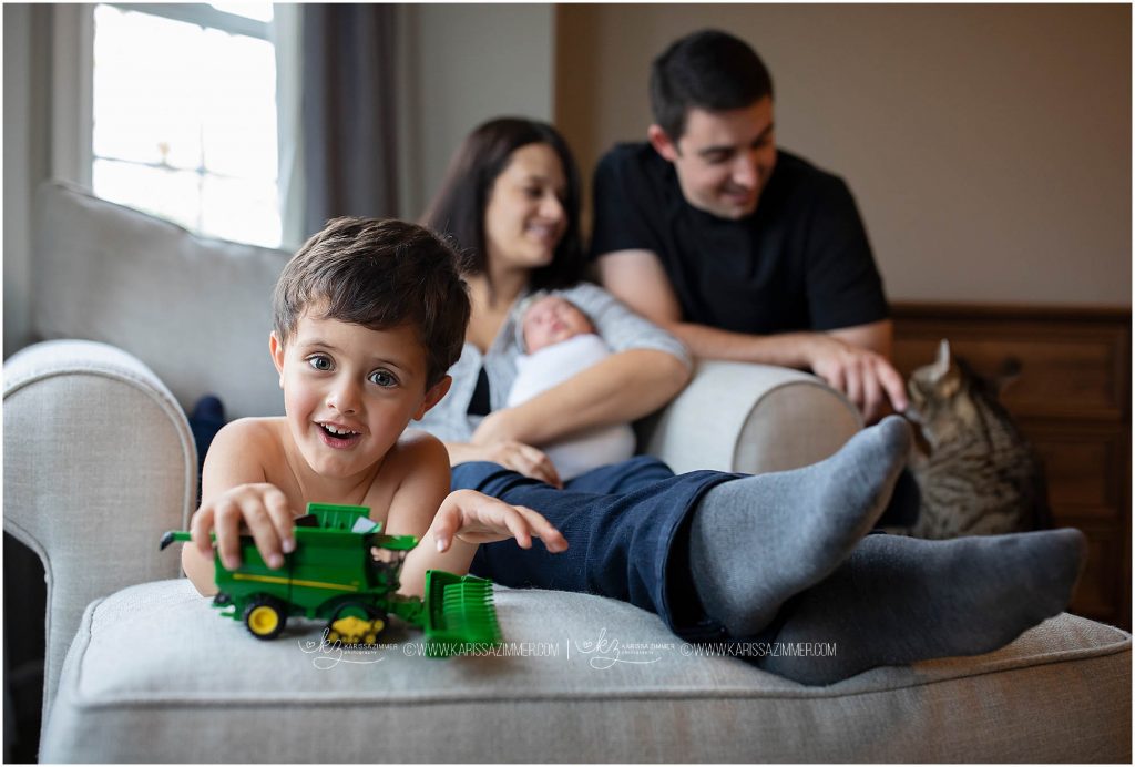 family poses in their home during lifestyle newborn photography session with camp hill newborn photographer