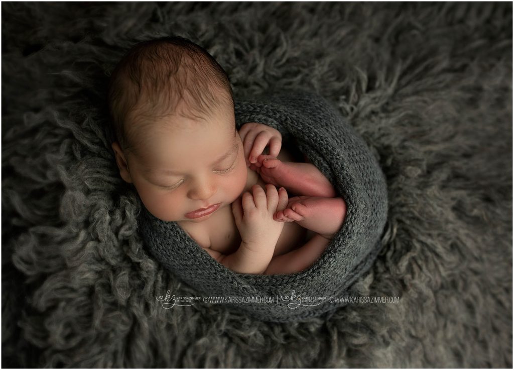 baby boy is wrapped and photographed by camp hill newborn photographer