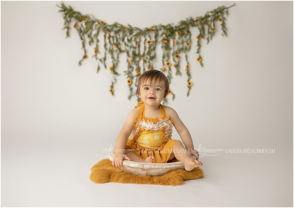 baby girl smiles for camp hill cake smash photographer