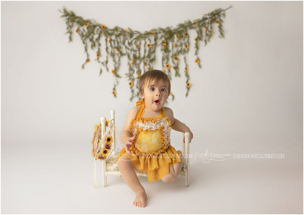 baby girl looks surprised at her first birthday session with karissa zimmer photography in camp hill PA
