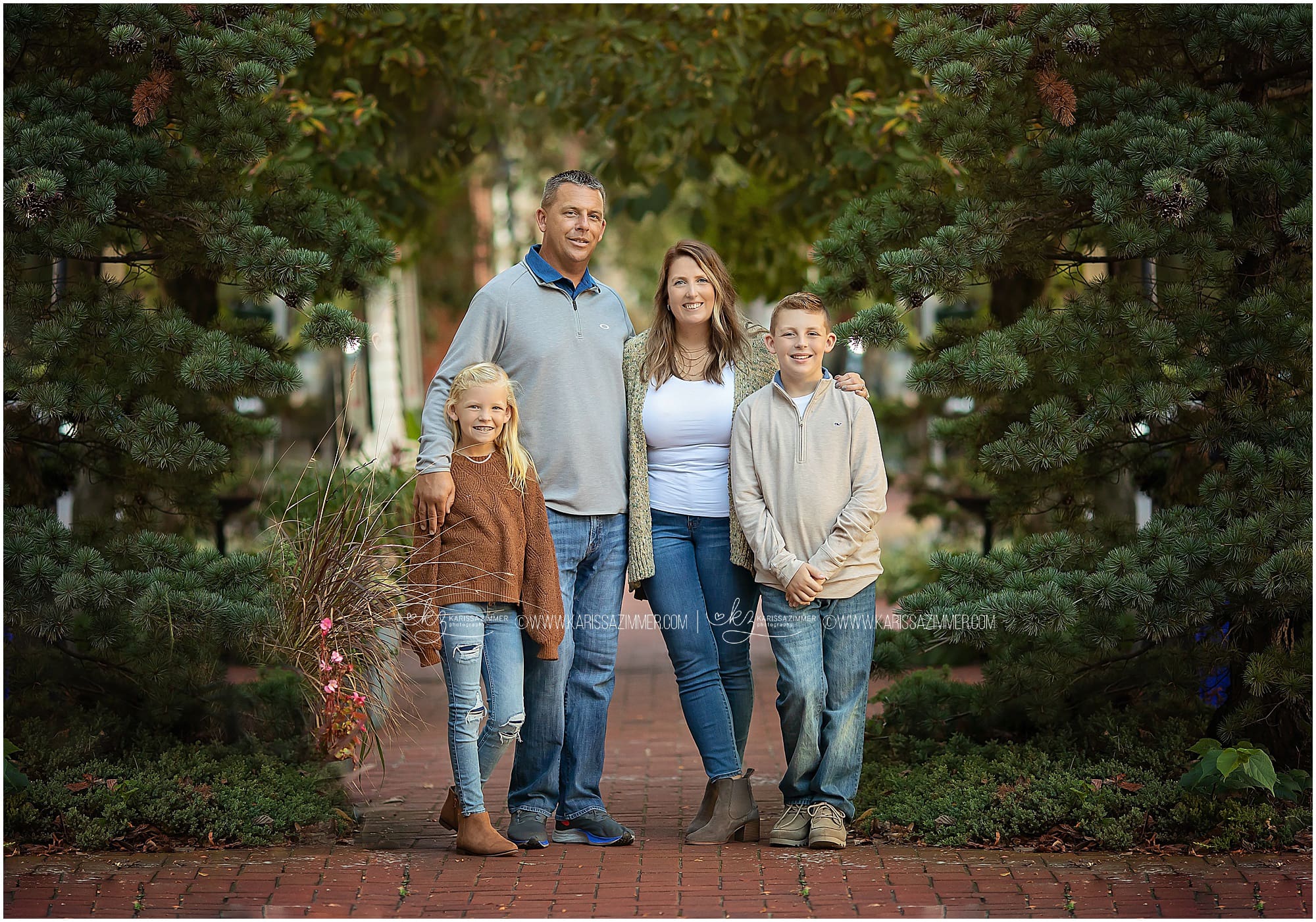 Family Of Four Sit Together In A Field Background, Fun Family Poses For  Picture, Fun, Family Background Image And Wallpaper for Free Download