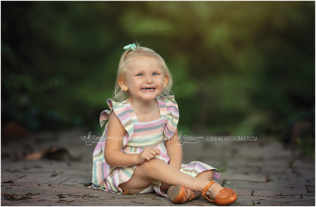 Little girl smiles big for Family Photographer, Karissa Zimmer