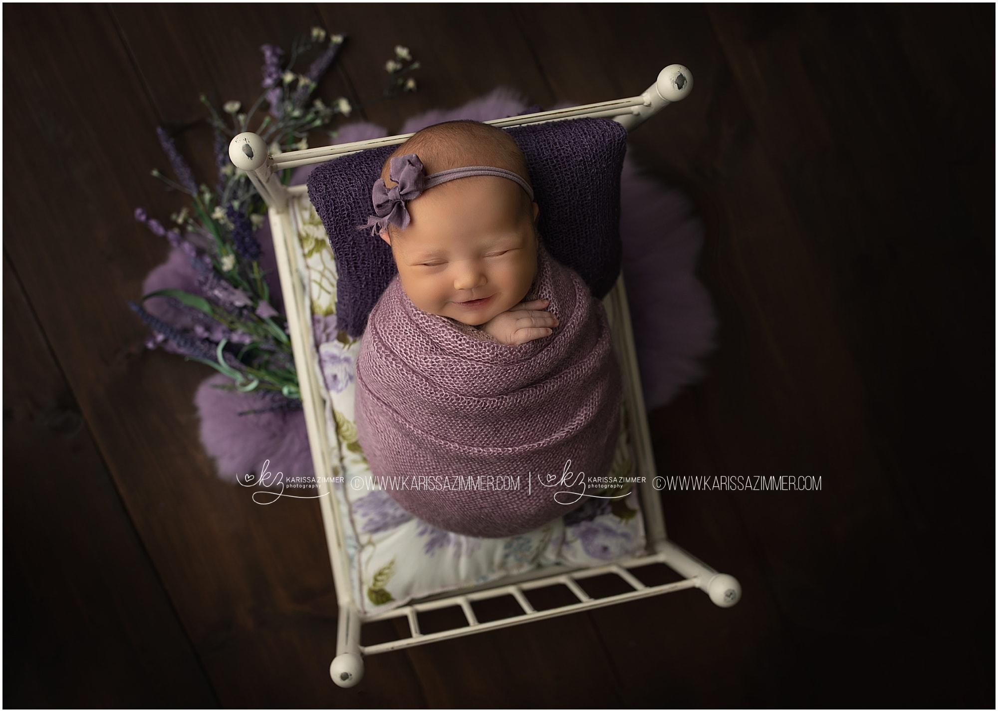 Mechanicsburg Professional newborn photographer captures image of newborn baby girl smiling during photoshoot in studio