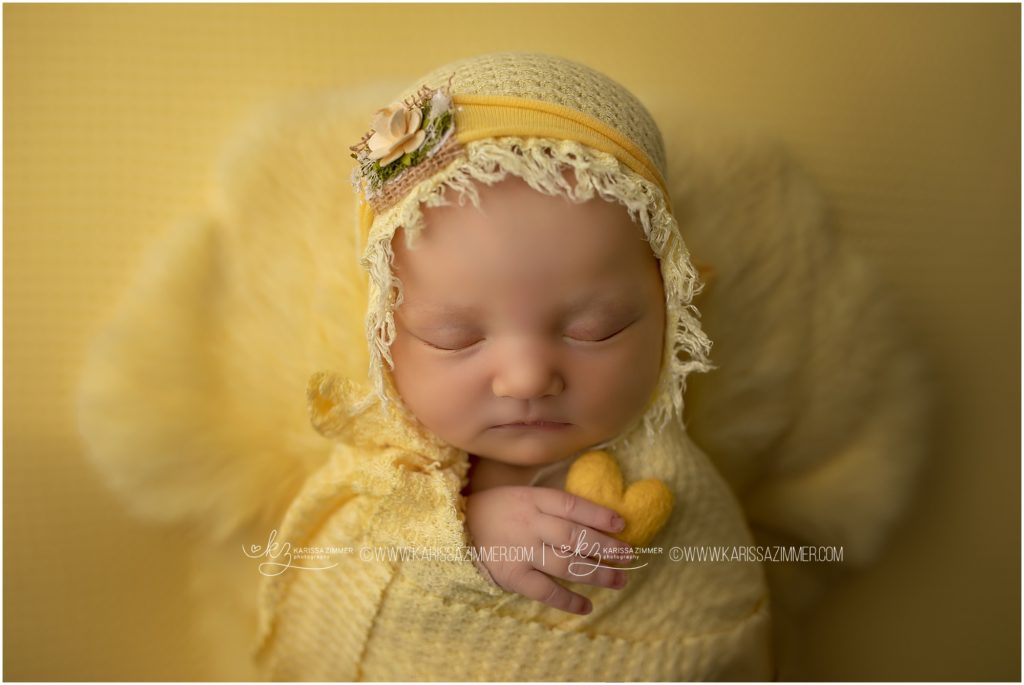 Newborn Baby girl photographed on yellow in mechanicsburg PA newborn photography studio
