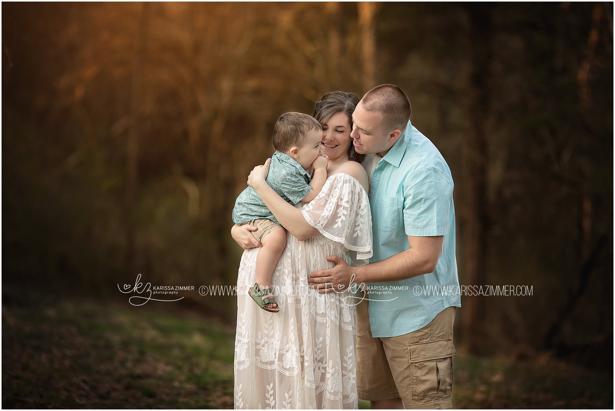 family of 3 embraces at their maternity photography session