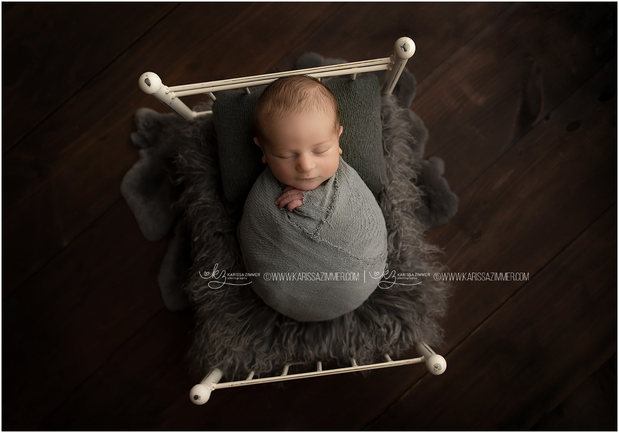 Newborn baby boy photographed on tiny bed prop in camp hill photography studio