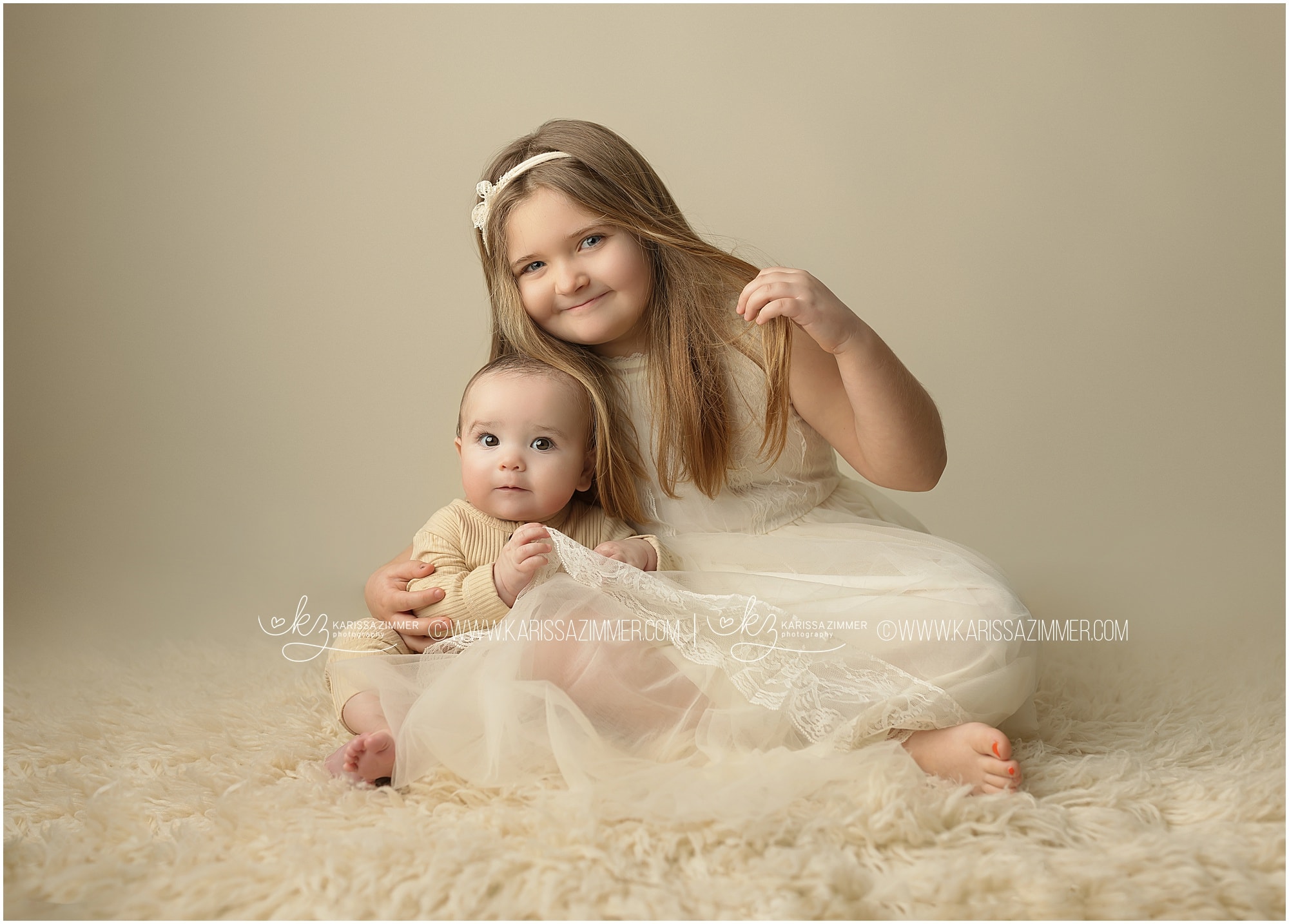 baby boy with older sister in photography studio