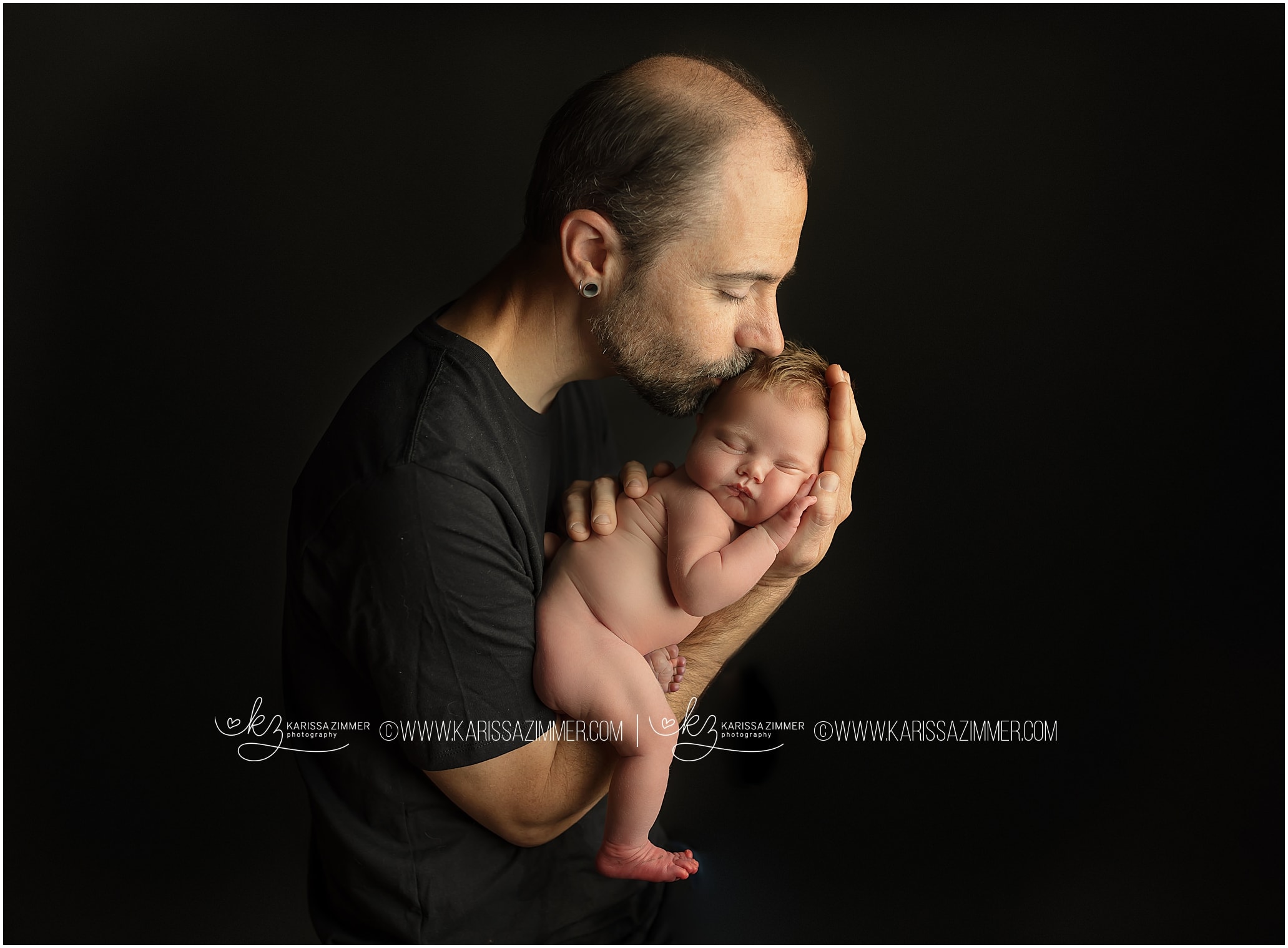 Father holds baby girl for newborn photos near Harrisburg PA