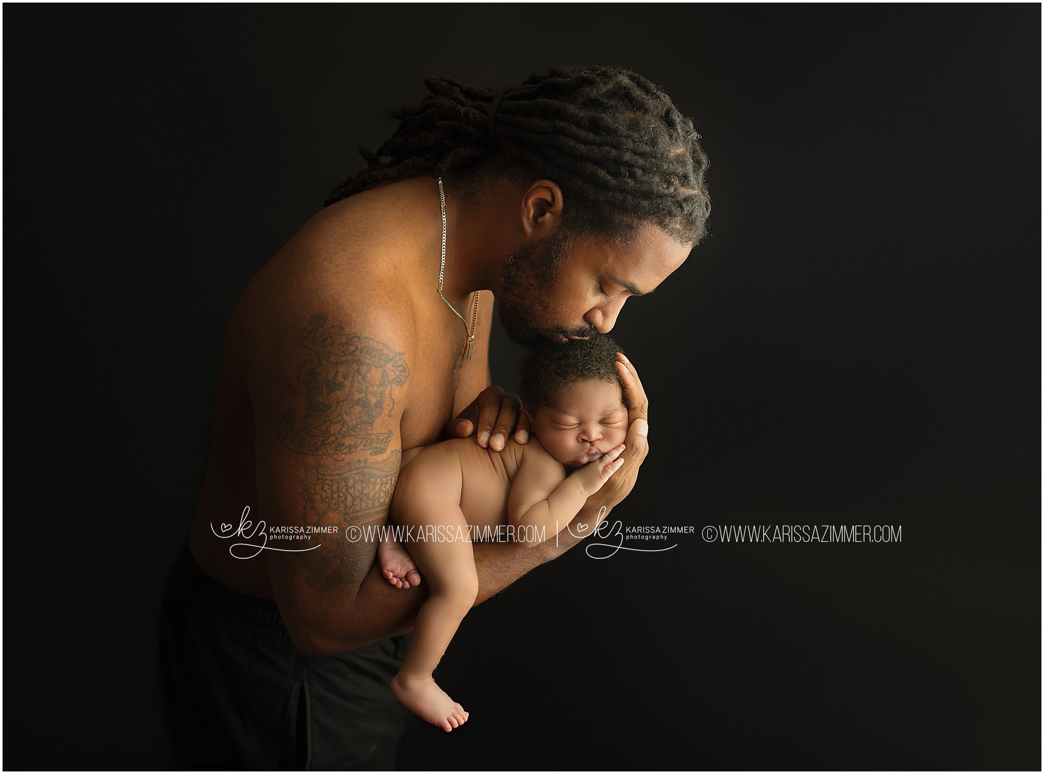 A dad kisses his newborn son while posing for newborn photos with Karissa Zimmer Photography