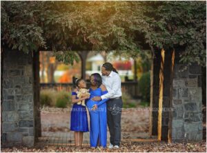 A Family of 3 poses while anxiously awaiting the arrival of a newborn baby boy at their outdoor family and maternity photography session in Hershey PA