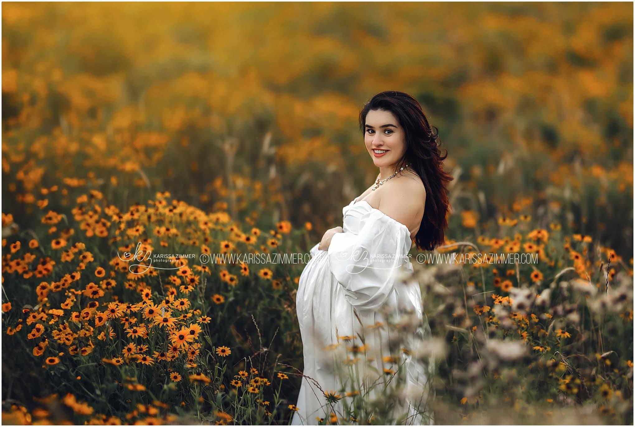 Best Hershey Maternity Photographer captures a beautiful image of a pregnant mom to be in a field of yellow flowers.