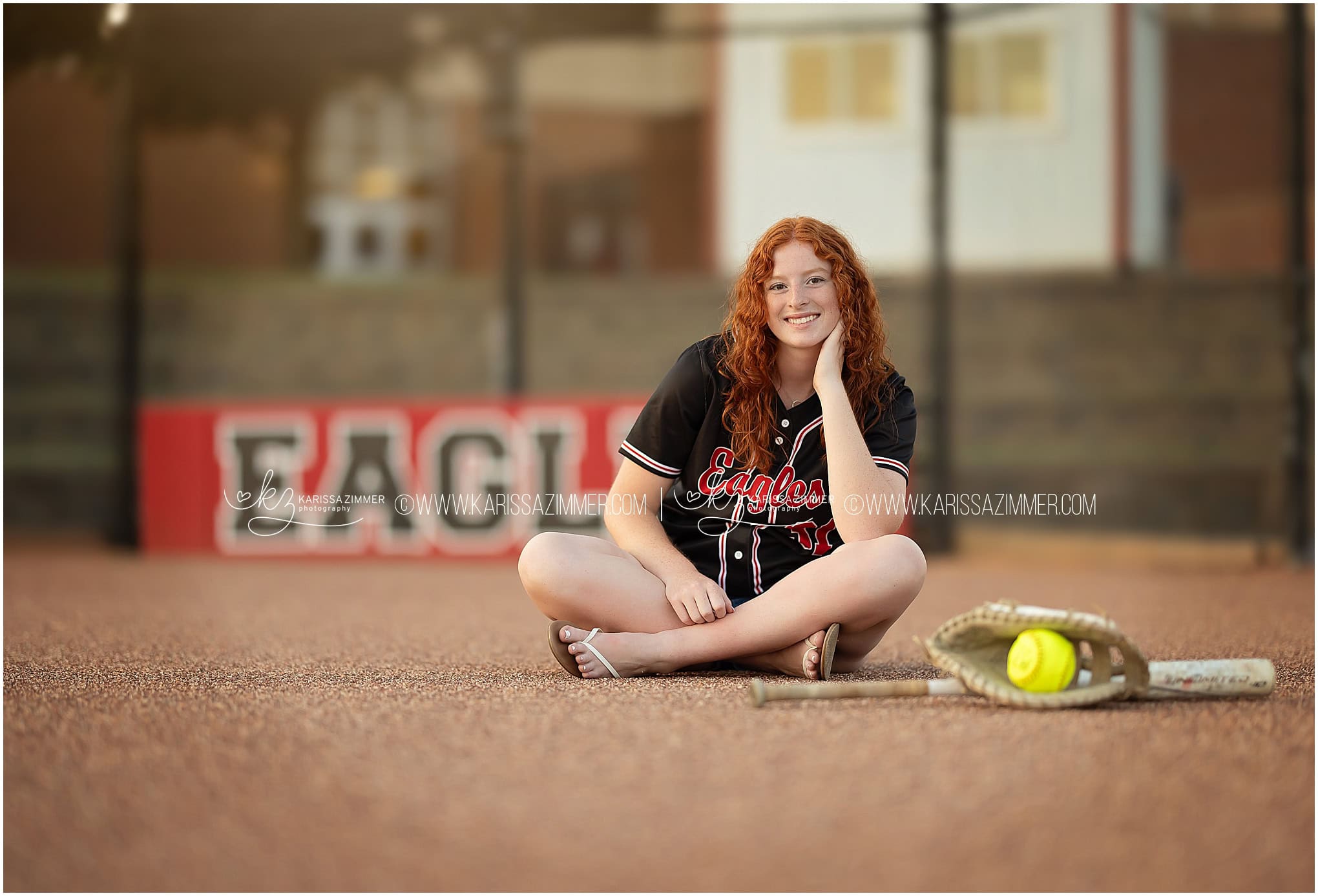 Cumberland Valley High School Senior poses on the school softball field for her senior photos with Karissa Zimmer Photography