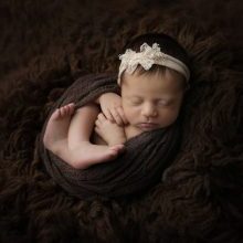 Karissa zimmer photography captures newborn girl on brown background near harrisburg pa